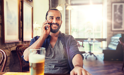 Image showing man with smartphone and beer calling at bar or pub