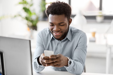 Image showing businessman with smartphone at office