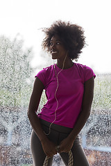 Image showing portrait of young afro american woman in gym while listening mus