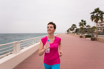 Image showing woman busy running on the promenade