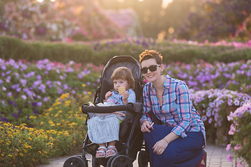 Image showing mother and daughter in flower garden