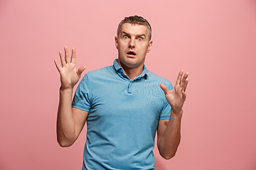 Image showing Portrait of the scared man on pink