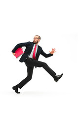 Image showing Businessman running with a folder on white background