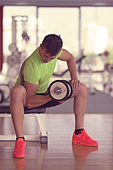 Image showing handsome man working out with dumbbells