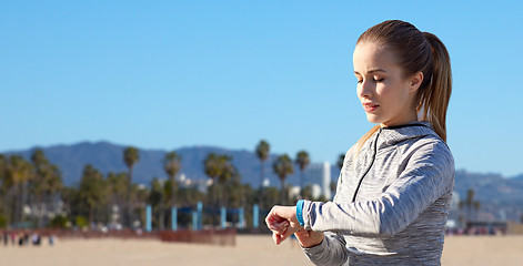 Image showing woman with fitness tracker training outdoors