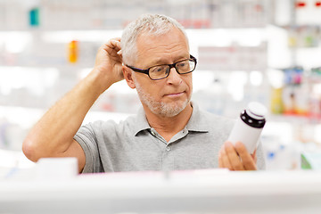 Image showing senior male customer with drug at pharmacy