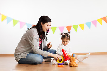 Image showing mother and baby daughter playing with pyramid toy