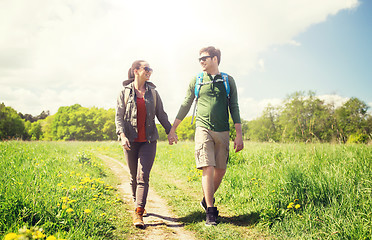 Image showing happy couple with backpacks hiking outdoors