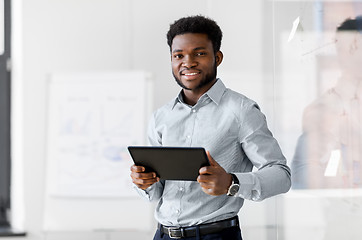 Image showing smiling businessman with tablet pc at office