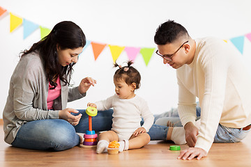 Image showing baby girl with parents playing with pyramid toy