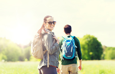 Image showing happy couple with backpacks hiking outdoors