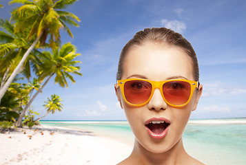 Image showing happy woman or teenage girl in sunglasses on beach