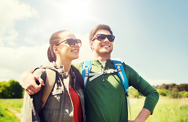 Image showing happy couple with backpacks hiking outdoors