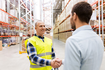 Image showing worker and businessman with clipboard at warehouse