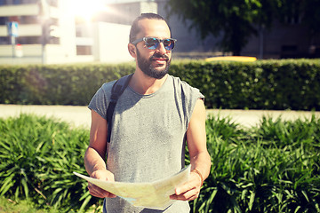 Image showing man traveling with backpack and map in city