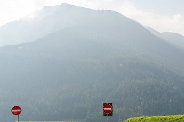 Image showing Road signs in misty mountains