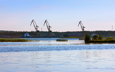 Image showing Port With Loading Cranes On The River Bank