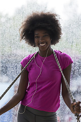 Image showing portrait of young afro american woman in gym while listening mus