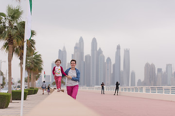 Image showing mother and cute little girl on the promenade