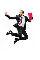 Image showing Funny cheerful businessman jumping in air over white background