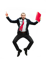 Image showing Funny cheerful businessman jumping in air over white background