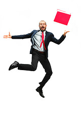 Image showing Funny cheerful businessman jumping in air over white background