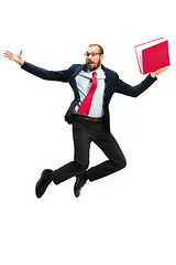 Image showing Funny cheerful businessman jumping in air over white background