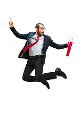 Image showing Funny cheerful businessman jumping in air over white background