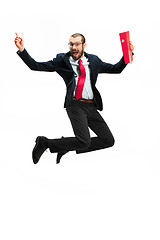 Image showing Funny cheerful businessman jumping in air over white background