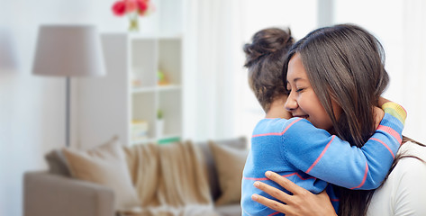 Image showing happy mother and daughter hugging at home