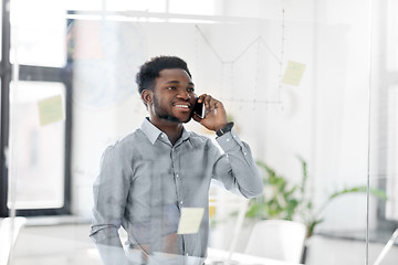 Image showing businessman calling on smartphone at office