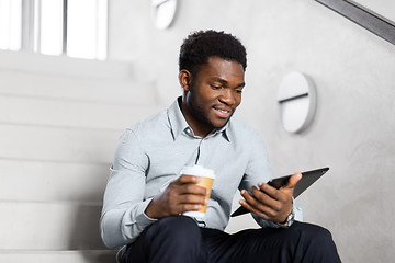 Image showing businessman with tablet pc and coffee on stairs