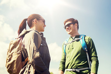 Image showing happy couple with backpacks hiking outdoors