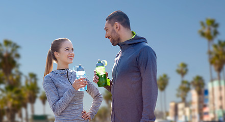 Image showing couple of sportsmen with water over venice beach