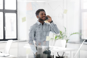 Image showing businessman calling on smartphone at office