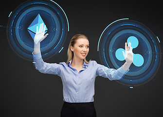 Image showing businesswoman with cryptocurrency holograms