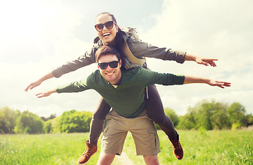 Image showing happy couple with backpacks having fun outdoors