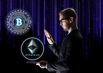 Image showing businessman with tablet pc and cryptocurrency