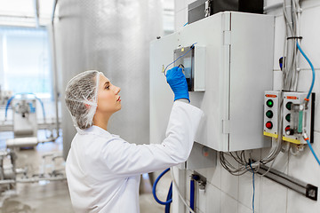 Image showing woman programming computer at ice cream factory