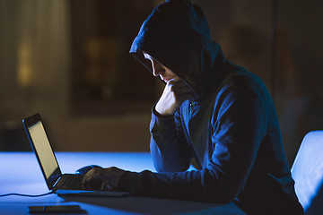 Image showing hacker using laptop computer for cyber attack