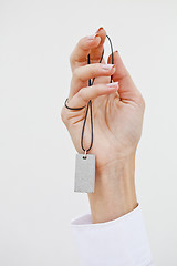 Image showing Hand holding stylish necklace.