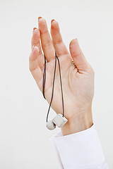 Image showing Hand holding stylish necklace.