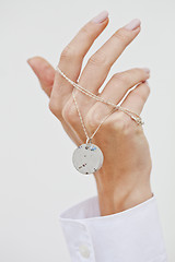 Image showing Hand holding stylish necklace.