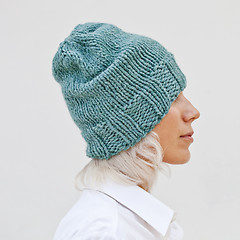 Image showing Pretty woman in warm turquoise beanie wool hat.