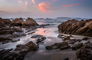 Image showing Coastal rocks and reflections in dawn hours