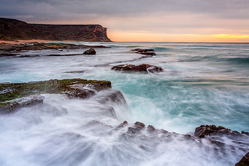 Image showing Coastal sunrise waves break over rocks in Royal National Park