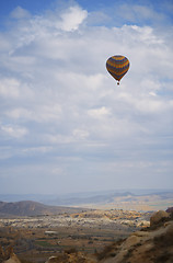 Image showing Hot air balloon flying over the rocky land