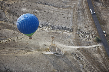 Image showing Blur hot air balloon flying over the road with motor transport