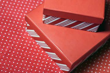 Image showing Christmas gift boxes on a red wrapping paper