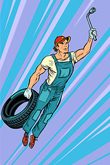 Image showing man mechanic tire. flying superhero help